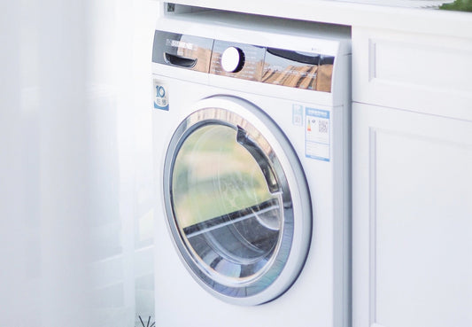 Picture of a front load washer inside a white cabinet