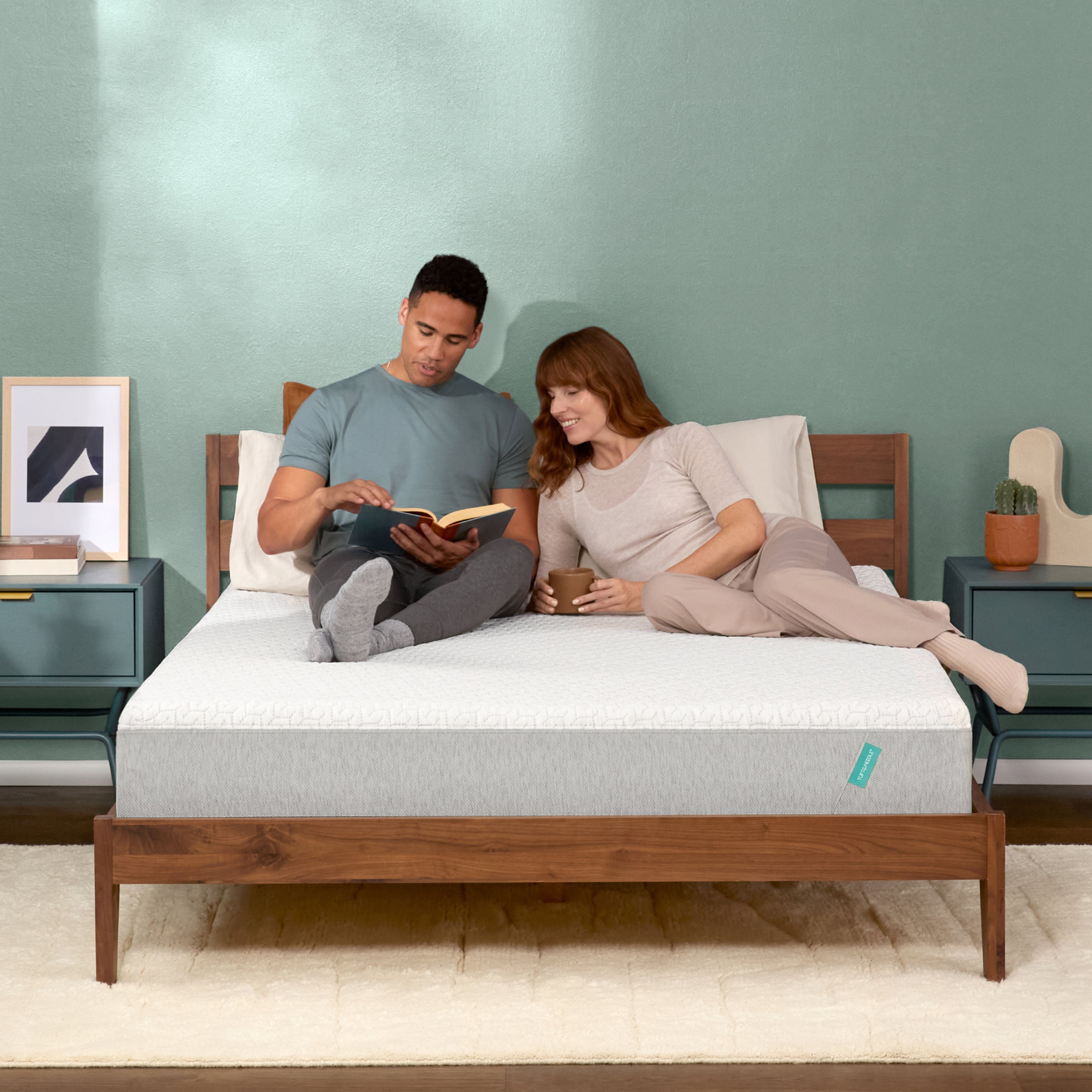 Couple lounges on mint mattress 