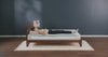 woman rolling on to her side on a foam mattress showing the inside layers of the mattress move